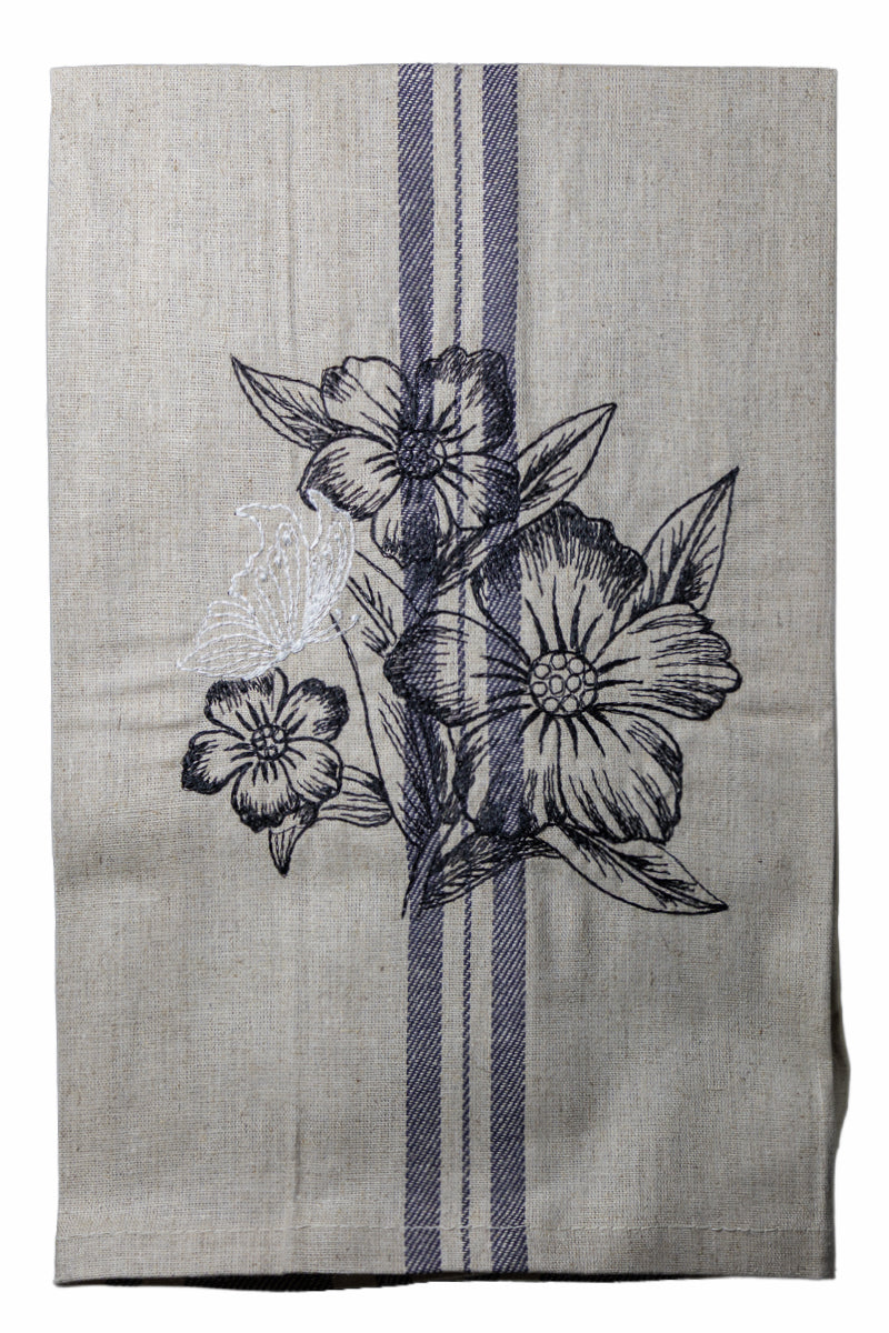 Dettaglio del ricamo Asciugapiatti ricamato con anemoni e farfalla della collezione Vintage Stripes Noir Botanique su fondo neutro.