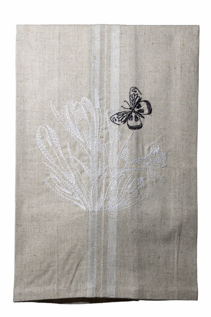 Dettaglio del ricamo Asciugapiatti ricamato con crocus e farfalla della collezione Vintage Stripes Noir Botanique su fondo neutro.