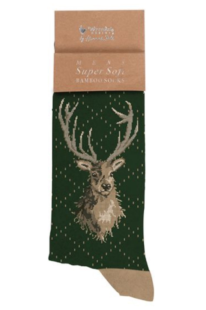Calza da uomo Wrendale Designs in bambù verde scuro con ricamo della testa di un cervo con grandi corna, presentata su sfondo neutro con cartoncino kraft del brand.